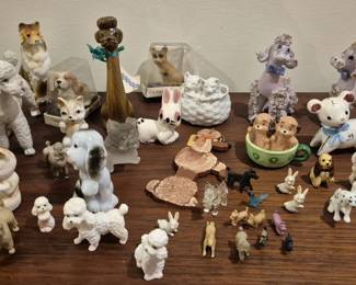 4054 - Group Lot of Ceramic & Porcelain Dog Figures (Description): Group lot of dogs featuring a charming  collection of ceramic and porcelain figurines  in various sizes and styles. The assortment  includes spaghetti-trim poodles in white,  pink, and lavender, a collie, dalmatians, terriers, and other breeds. Also included are  several miniature dog figures, a ceramic  basket with puppy, and decorative dog-themed  pieces. A delightful collection for dog  lovers and figurine collectors.