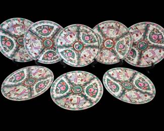 494 - 8 Rose Medallion Plates 10" (Description): Set of eight Rose Medallion porcelain plates  in the traditional Chinese export style. Each  plate features the classic quadrant design  with alternating panels of court figures in  domestic scenes and floral medallions with pink peonies surrounded by green foliage. The  central medallion displays a bird and floral  motif encircled by a gilt border.  Hand-painted in the characteristic Rose  Medallion palette of pink, green, and gold