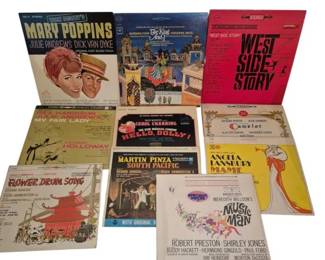 3913 - Collection of Show Tune Vinyl Records (Description): A collection of vintage show tune records  featuring classic Broadway and film musical  soundtracks. The collection includes beloved  titles such as Mary Poppins, West Side Story,  The King and I, My Fair Lady, Hello Dolly!, Camelot, Flower Drum Song, South Pacific,  Mame starring Angela Lansbury, and The Music  Man. These vinyl albums represent the golden  age of musical theater and film soundtracks,  with both original cast recordings and motion