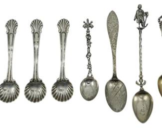 113 - 8 Sterling & Silver Plate Spoons (Description): A collection of eight sterling silver and  silver plate spoons from varying makers. The  assortment includes decorative salt spoons  with shell-shaped bowls and ornate handles,  as well as souvenir and figural spoons featuring detailed finials. The collec