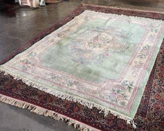This lot features a Chinese wool area rug that measures, 11′ x 8′. 