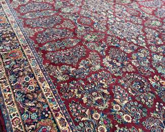 This lot features a stunning 100% wool Red Sarouk Karastan rug that measures, 14′ H x 10′ W.