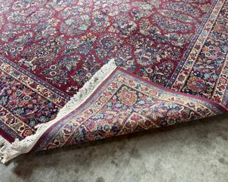 This lot features a stunning 100% wool Red Sarouk Karastan rug that measures, 14′ H x 10′ W.