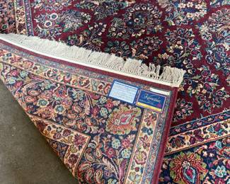 This lot features a stunning 100% wool Red Sarouk Karastan rug that measures, 14′ H x 10′ W.