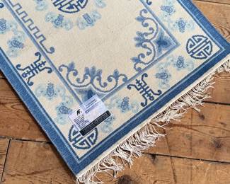 This lot features a Tibetan style Chinese silk rug that measures, 36” H x 24” W.