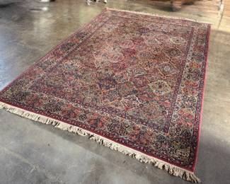 This lot features a Karastan multi-color panel Kirman area rug that measures, 14′ x 10′. 