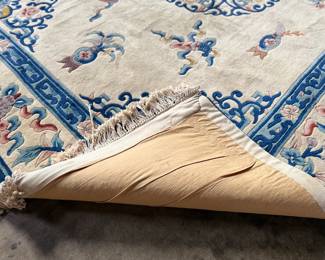 This lot features a hand made 100% wool rug from the People’s Republic of China in a cream color. Measures, 138” H x 99” W.