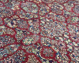 This lot features a stunning 100% wool Red Sarouk Karastan rug that measures, 14′ H x 10′ W.