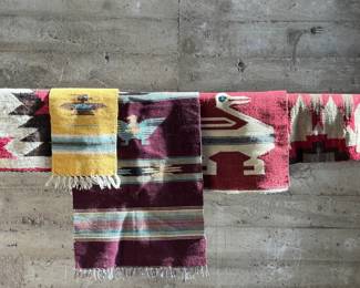 This lot features a collection of vintage handwoven rugs & tapestries that appear to primarily be from Central & South American countries. 