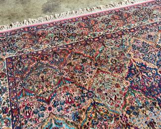 This lot features a Karastan multi-color panel Kirman area rug that measures, 14′ x 10′. 