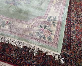 This lot features a Chinese wool area rug that measures, 11′ x 8′. 