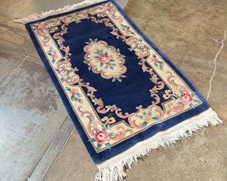 This lot features an antique Chinese floral handmade rug that measures, 60” H x 36” W.