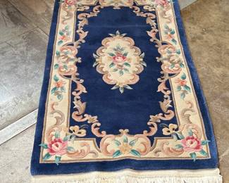 This lot features an antique Chinese floral handmade rug that measures, 60” H x 36” W.