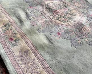 This lot features a Chinese wool area rug that measures, 11′ x 8′. 
