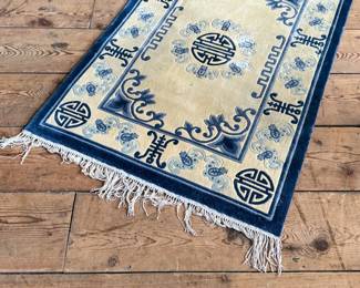This lot features a Tibetan style Chinese silk rug that measures, 36” H x 24” W.