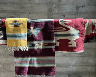 This lot features a collection of vintage handwoven rugs & tapestries that appear to primarily be from Central & South American countries. 