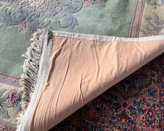 This lot features a Chinese wool area rug that measures, 11′ x 8′. 