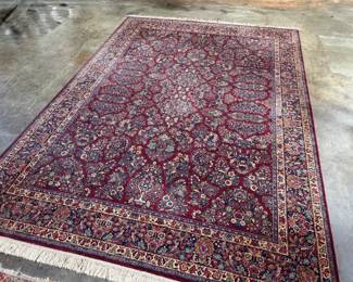 This lot features a stunning 100% wool Red Sarouk Karastan rug that measures, 14′ H x 10′ W.