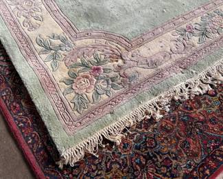 This lot features a Chinese wool area rug that measures, 11′ x 8′. 