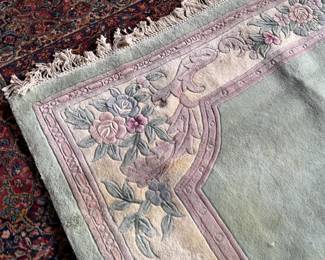 This lot features a Chinese wool area rug that measures, 11′ x 8′. 