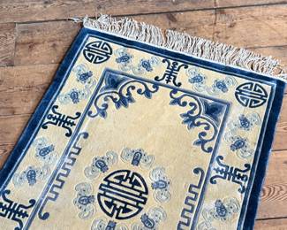 This lot features a Tibetan style Chinese silk rug that measures, 36” H x 24” W.