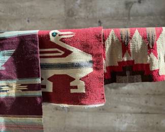 This lot features a collection of vintage handwoven rugs & tapestries that appear to primarily be from Central & South American countries. 