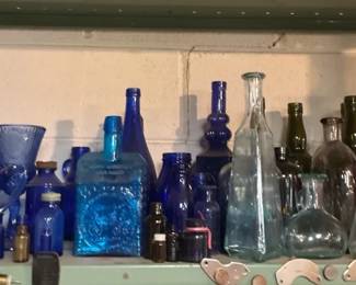 Collection of Blue and Purple Glass Bottles, Vases, and Decorative Glassware