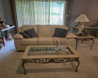 Heavy iron tables and white leather sofa