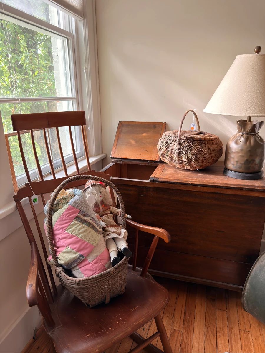 Antique wooden rocking chair, blanket chest and woven baskets