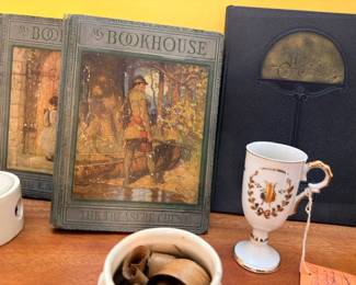 Vintage "My Bookhouse" illustrated children's books and gold-trimmed ceramic mug