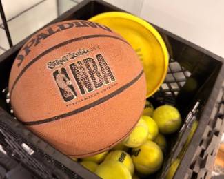 Spalding NBA basketball and sports balls in crate
