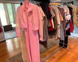 Racks of vintage women's clothing incl. pink lace dress