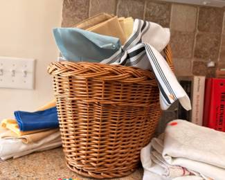 Wicker basket of kitchen linens & towels