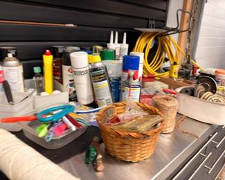 Garage workbench with spray paints, lubricants, caulk and supplies