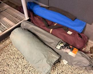 Camping tents and sleeping bags in carry bags