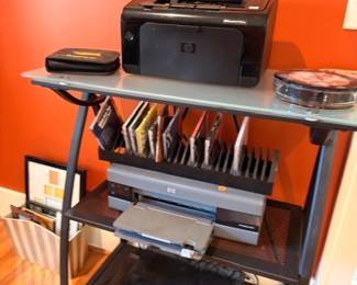 HP printer and electronics on black metal rolling cart with glass shelf