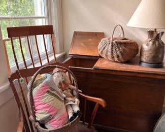 Antique wooden rocking chair, blanket chest and woven baskets