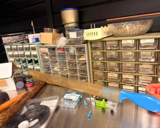 Hardware organizer cabinets with screws, bolts and small parts on workbench