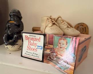 Vintage cast iron monkey figure, baby shoes and bronzing kit