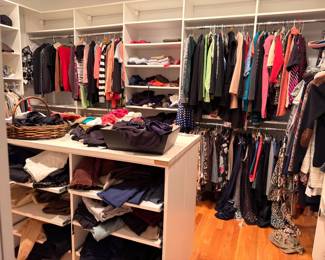 Large walk-in closet of women's clothing