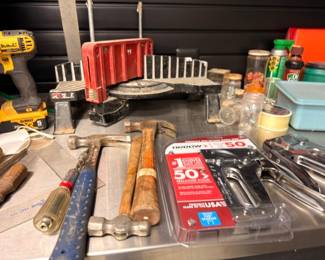 DeWalt drill, hammers and assorted hand tools on workbench