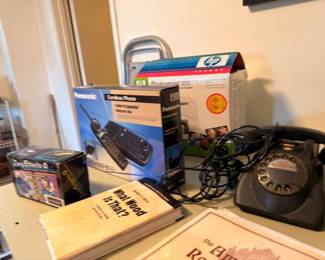 Panasonic cordless phone, HP scanner, vintage rotary telephone, and books