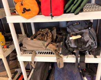 Shelves of backpacks, duffel bags and camping gear