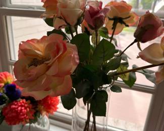 Clear glass vases with faux floral arrangements