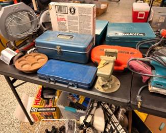 Makita and Black & Decker power tools with metal tackle and tool boxes