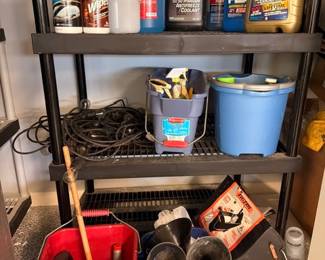 Garage shelf with motor oil, automotive fluids, buckets, and tools