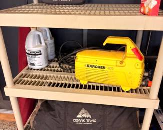 Shelves with Karcher pressure washer and Washington and Lee University and Ozark Trail bags