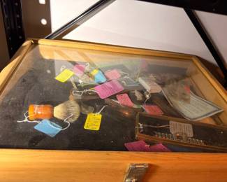 Glass display case of small collectibles and accessories