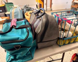 Duffel bags, luggage and crate of sports balls