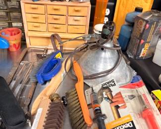 Workbench with wire brushes, hand tools, hardware organizer and lubricants